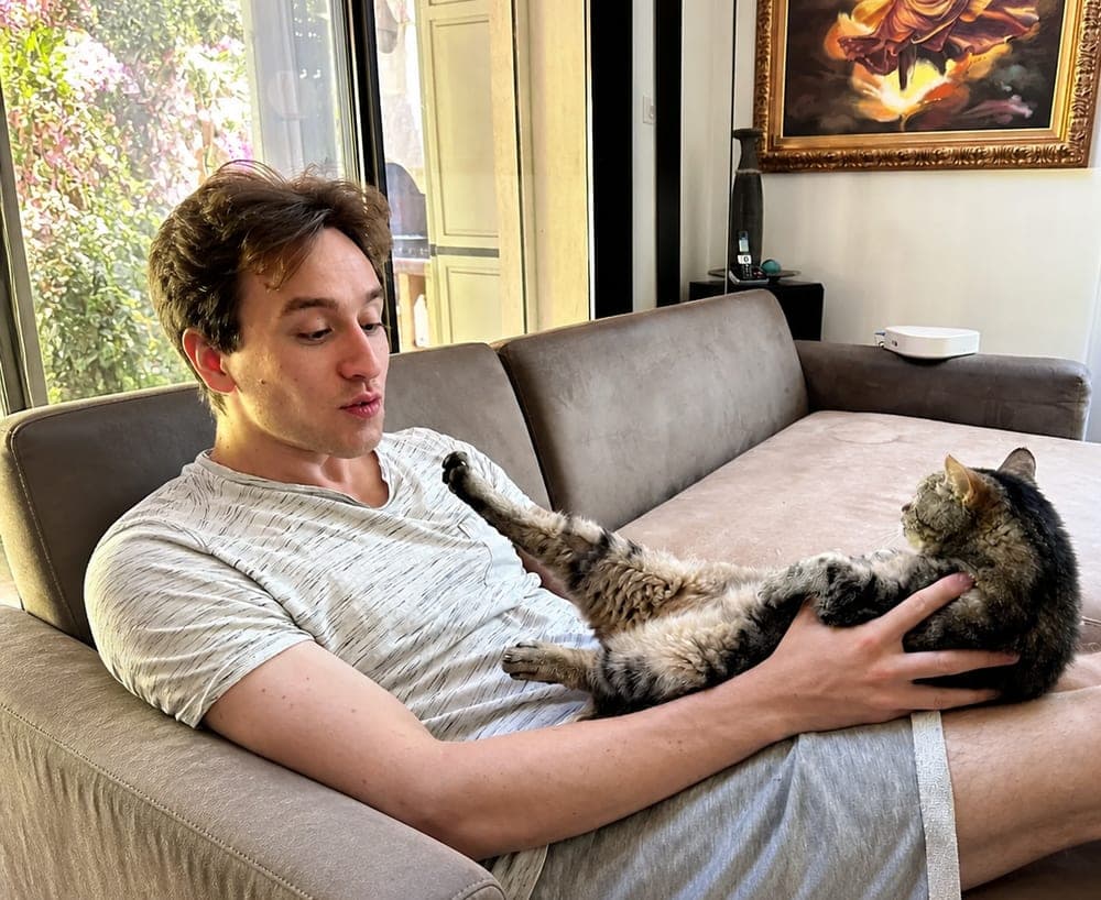 Kevin Messali at home with his cat